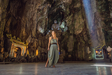 Young woman tourist in Huyen Khong Cave with shrines, Marble mountains, Vietnam