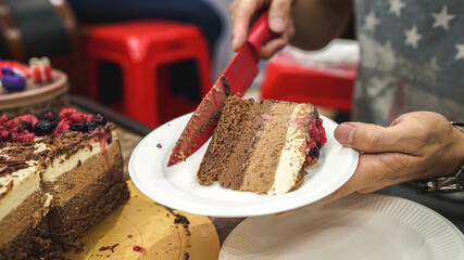 piece of chocolate cake on plate, cutting three mousse chocolate cake, white milk and black chocolate, celebrating a birthday, delicious homemade cake