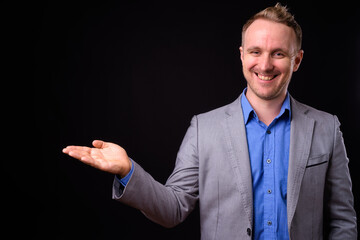 Portrait of happy handsome businessman in suit with blond hair