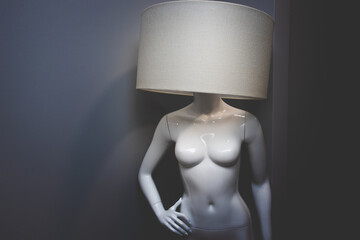 Female mannequin with a lamp on her head