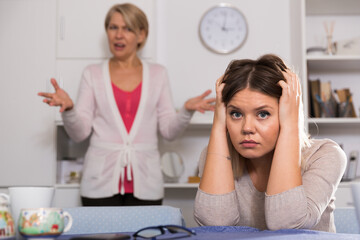 Dissatisfied elderly mother chastises saddened grown-up daughter