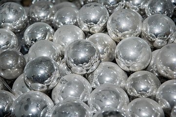 Pile of glass silvered half-finished dusty balls (billets) of future christmas baubles