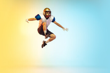 Fototapeta na wymiar Flight. American football player isolated on gradient studio background in neon light. Professional sportsman during game playing in action and motion. Concept of sport, movement, achievements.