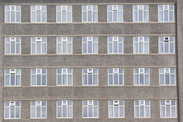 Fototapeta na wymiar the facade of the concrete building with Windows
