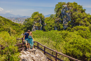 Fototapeta na wymiar Couple of tourists on the background of Beautiful Marble mountains and Da Nang, Vietnam
