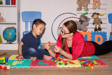 Shot of a speech therapist during a session with a little boy