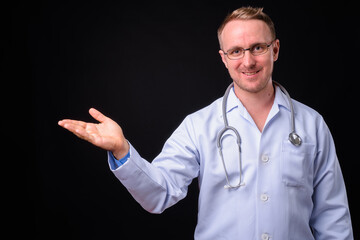 Portrait of happy handsome man doctor with blond hair