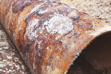 Fragments of old large water pipes. After many years of operation, corroded metal pipe destroyed....
