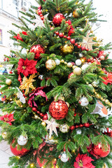 close up of christmas trees decoration with toys and garlands. City festive decor during winter holidays