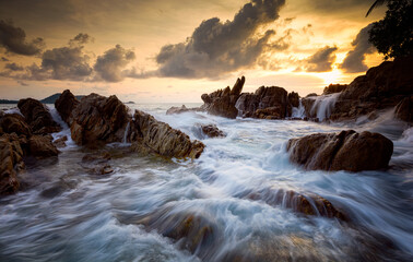 Fototapeta na wymiar Seascape with rock in sunset scenery background
