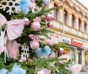 close up of christmas trees decoration with toys and garlands. City festive decor during winter holidays