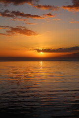 Fototapeta na wymiar Sunset on the atlantic ocean. Swimming pool on the background of the sun setting in the ocean.
