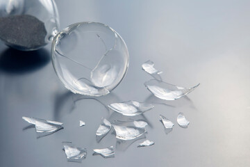 broken hourglass. waste of time. end of opportunity. stop measuring hours. shards of glass. shattered hope.