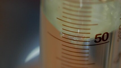 test tube is filled with liquid at the 50 mark during a science experiment