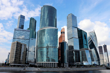 Fototapeta na wymiar View to skyscrapers of Moscow city from the embankment of the Moscow river. Futuristic city in summer, concept of urbanization, russian economy