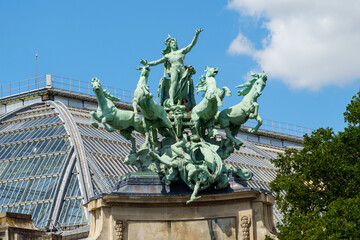 Fototapeta na wymiar Close-up view of bronze quadriga statue Harmony Triumphing over Discord on top of the Grand Palais in Paris (by Georges Recipon 1860 - 1920) - Paris, France