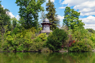 Fototapeta na wymiar Kiosk of the Emperor on the island of the lower lake in the Bois de Boulogne - Paris, France. It was built in 1852 on request of Napoleon III