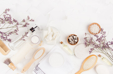 Natural rustic eco beige cosmetic products and accessories for body and skin care with lavender twigs on soft light white background, border.