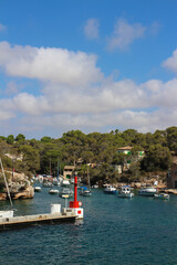 View of the Bay of Cala Figuera with many yachts against a blue sky with clouds. Majorca. Spain.