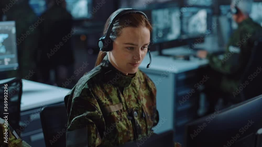 Aufkleber beautiful female military surveillance officer in headset working in central office hub for cyber op