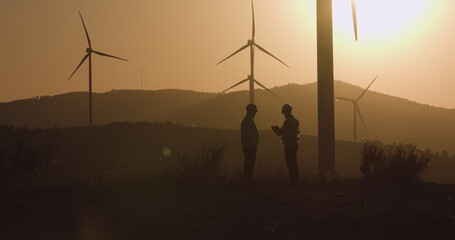 Two engineers made a deal at sunset, shaking hands