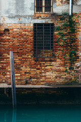 Venice Italy. Venice postcard. Old brick background next to canal.