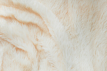 delicate soft background of plush fabric folds on white background. Copy space. Flat lay. loose folds on the fabric of faux fur of lilac color. Details of warm winter clothes