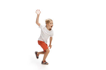 Energy. Happy kids, little and emotional caucasian boy jumping and running isolated on white background. Look happy, cheerful, sincere. Copyspace for ad. Childhood, education, happiness concept.