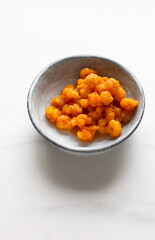 freshly picked cloudberries in rustic plate on white marble background with copy space