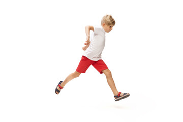 Fototapeta na wymiar Target. Happy kids, little and emotional caucasian boy jumping and running isolated on white background. Look happy, cheerful, sincere. Copyspace for ad. Childhood, education, happiness concept.