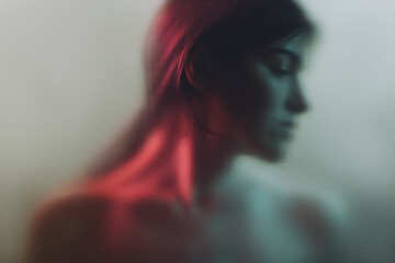 Art portrait. Feminine mystery. Sensual woman blur silhouette in neon red light gray fog with noise...