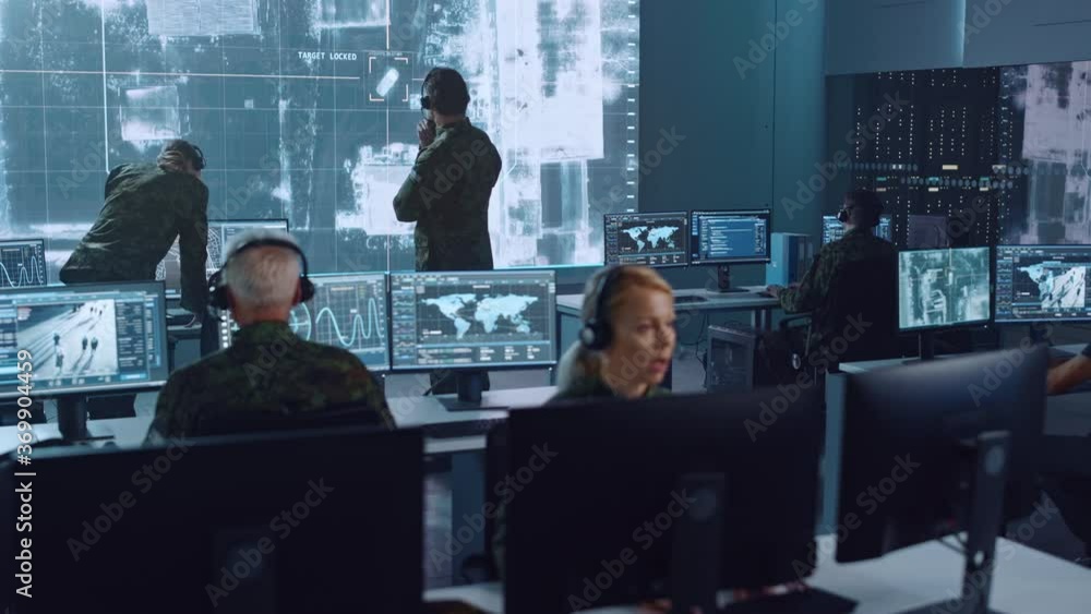 Poster Military Surveillance Team of Officers Locked a Target on a Vehicle from a Satellite and Monitor it on a Big Display in Office for Cyber Operations for Managing Security and Army Communications. 