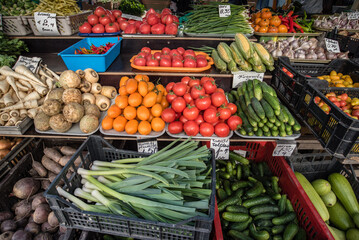 A colorful assortment of fresh fruits and vegetables neatly and attractively arranged on stands for sale at Riga Central Market, Latvia.