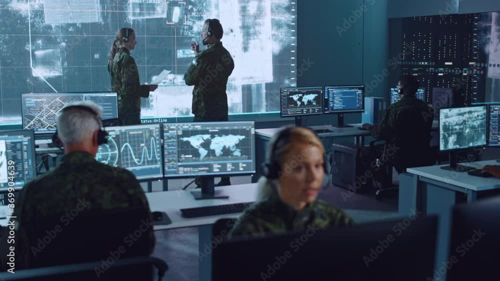 Poster Military Surveillance Team of Officers Locked a Target on a Vehicle from a Satellite and Monitor it on a Big Display in Office for Cyber Operations for Managing Security and Army Communications. 