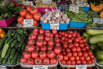 A colorful assortment of fresh fruits and vegetables neatly and attractively arranged on stands for sale at Riga Central Market, Latvia.