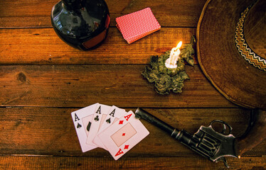 Wood Card Table in the Wild West, with whiskey, four aces hat and revolver