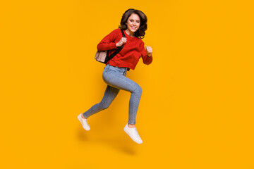 Fototapeta na wymiar Full length body size view of her she nice attractive lovely cheerful cheery wavy-haired girl jumping running university study isolated on bright vivid shine vibrant yellow color background