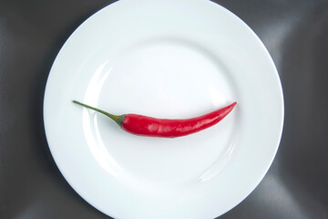 red hot pepper on a white plate. spices and vegetative food