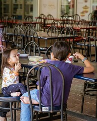 Malay asian children having lunch at a hawker local style restaurant.