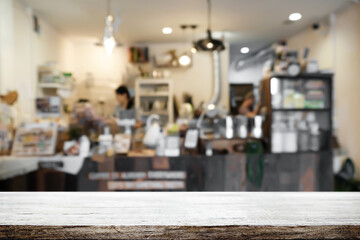 Empty wooden table space platform and blurred restaurant or coffee shop background for product display montage.