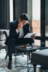 Handsome business man looking at tablet stock photo