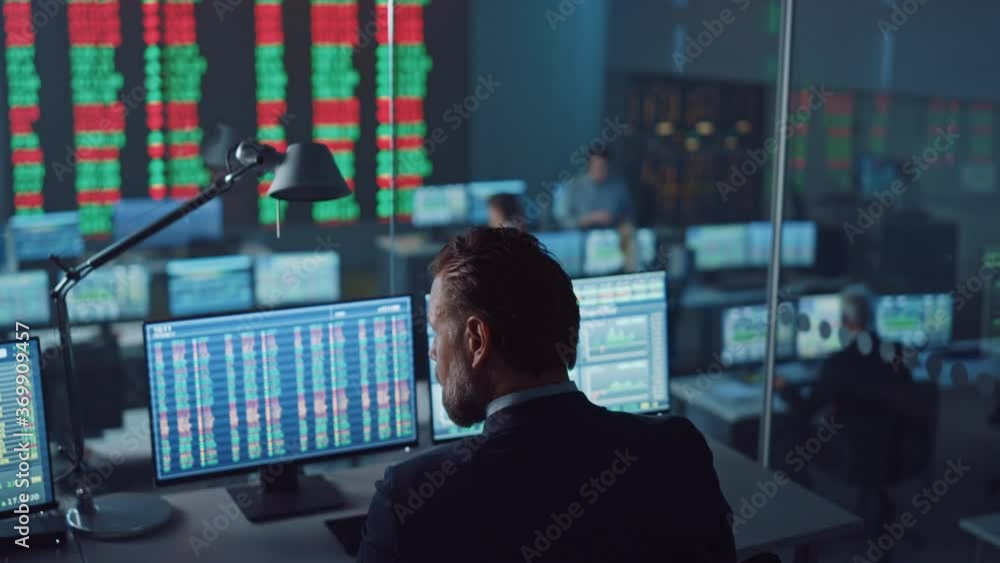 Poster Professional Financial Data Analysts Working in a Modern Monitoring Office with Live Analytics Feed on a Big Digital Screen. Monitoring Room with Finance Specialists Sit in Front of Computers. 
