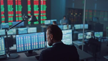 Professional Financial Data Analysts Working in a Modern Monitoring Office with Live Analytics Feed on a Big Digital Screen. Monitoring Room with Finance Specialists Sit in Front of Computers.  - Powered by Adobe