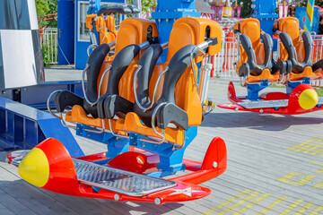 Amusement park carousel seat with safety devices