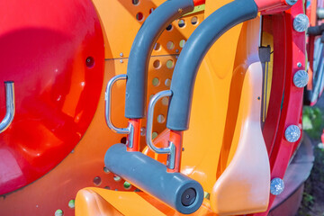 Amusement park carousel seat with safety devices