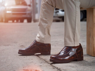 Shot of man fashion in stylish brown shoes leather with extra height in sole.