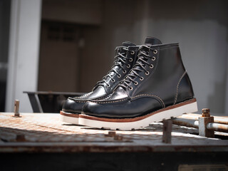 Men fashion black boots leather on the floor.