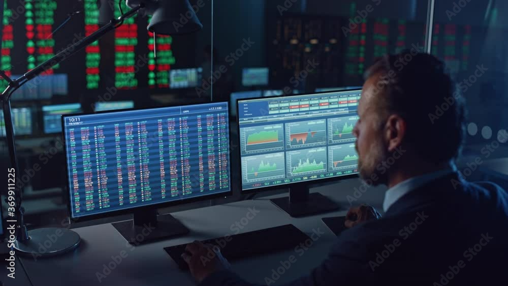 Poster Professional Financial Data Analysts Working in a Modern Monitoring Office with Live Analytics Feed on a Big Digital Screen. Monitoring Room with Finance Specialists Sit in Front of Computers. 