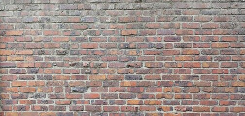 a rough brick wall consisting of red bricks