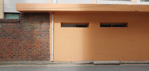 Orange house and red brick wall